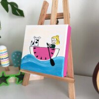 Whimsical cartoon of a smiling blonde girl with her hair in a top bun paddling a pink watermelon-slice boat across blue water, with a black-and-white spotted dog sitting in the front.